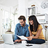 Couple sitting looking at laptop. 