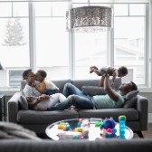 Family playing with young kids at home.