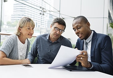 Couple sitting with an advisor. 