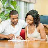 Couple using calculator. 