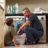 Dad and son doing laundry. 