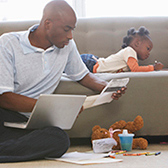 Father with daughter lying on couch.