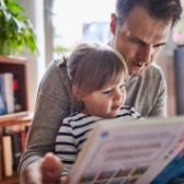 Father and daughter reading a book.