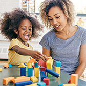 Mom and daughter playing with blocks.