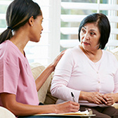 Woman giving keys to a man at a rental car counter. 