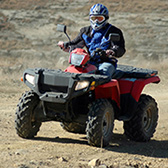 Man riding a red ATV. 