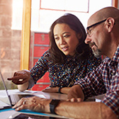 Couple looking at computer.