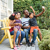 Family sitting on porch. 