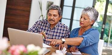 Mature couple budgeting at table. 