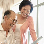 Older couple in home office. 