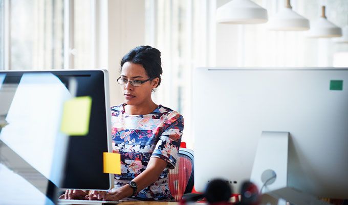 Woman browsing an office computer.