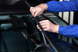 Replacing windshield wiper blades.